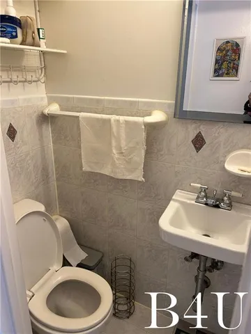 a bathroom with a sink mirror and toilet