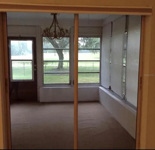 a view of room with window and a ceiling fan