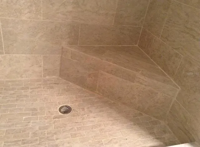 a kitchen with granite countertop white cabinets and sink