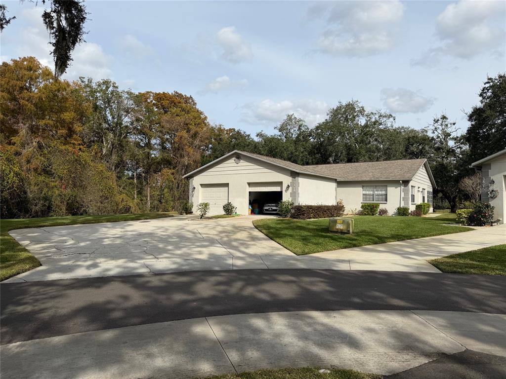 3818 River Oaks Court, Unit B New Port Richey, FL 34655 - Photo 3 of 7 a front view of a house with a yard and garage
