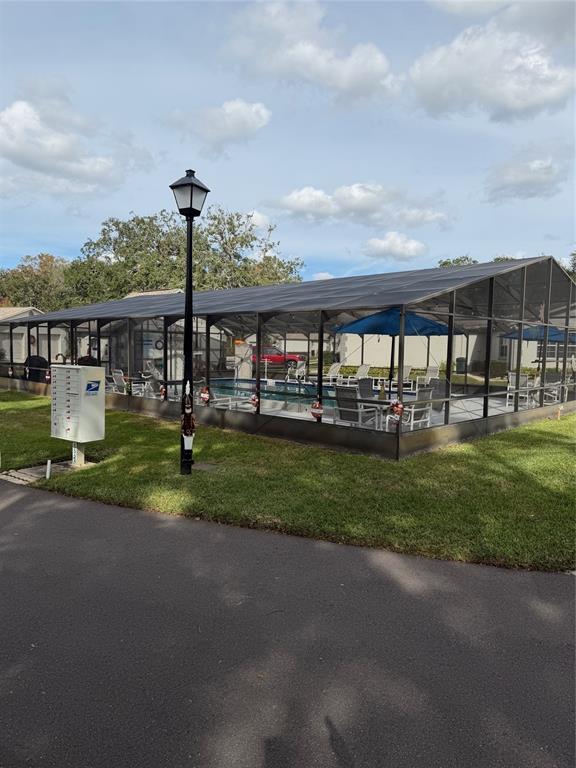 3818 River Oaks Court, Unit B New Port Richey, FL 34655 - Photo 6 of 7 a view of a house with a yard and lake view