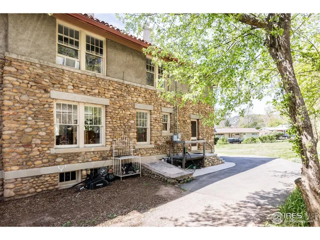 an aerial view of residential house with outdoor space and trees all around