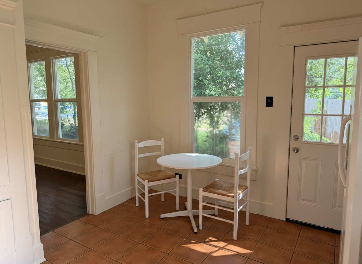 1136 Eleanor Street Austin, TX 78721 - Photo 6 of 30 Virtual Staged:
A cozy corner with a breakfast nook, offering a delightful view through a large window.