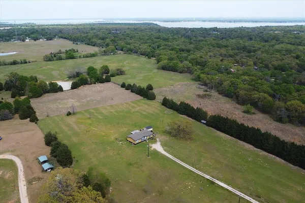 an aerial view of a house with a yard