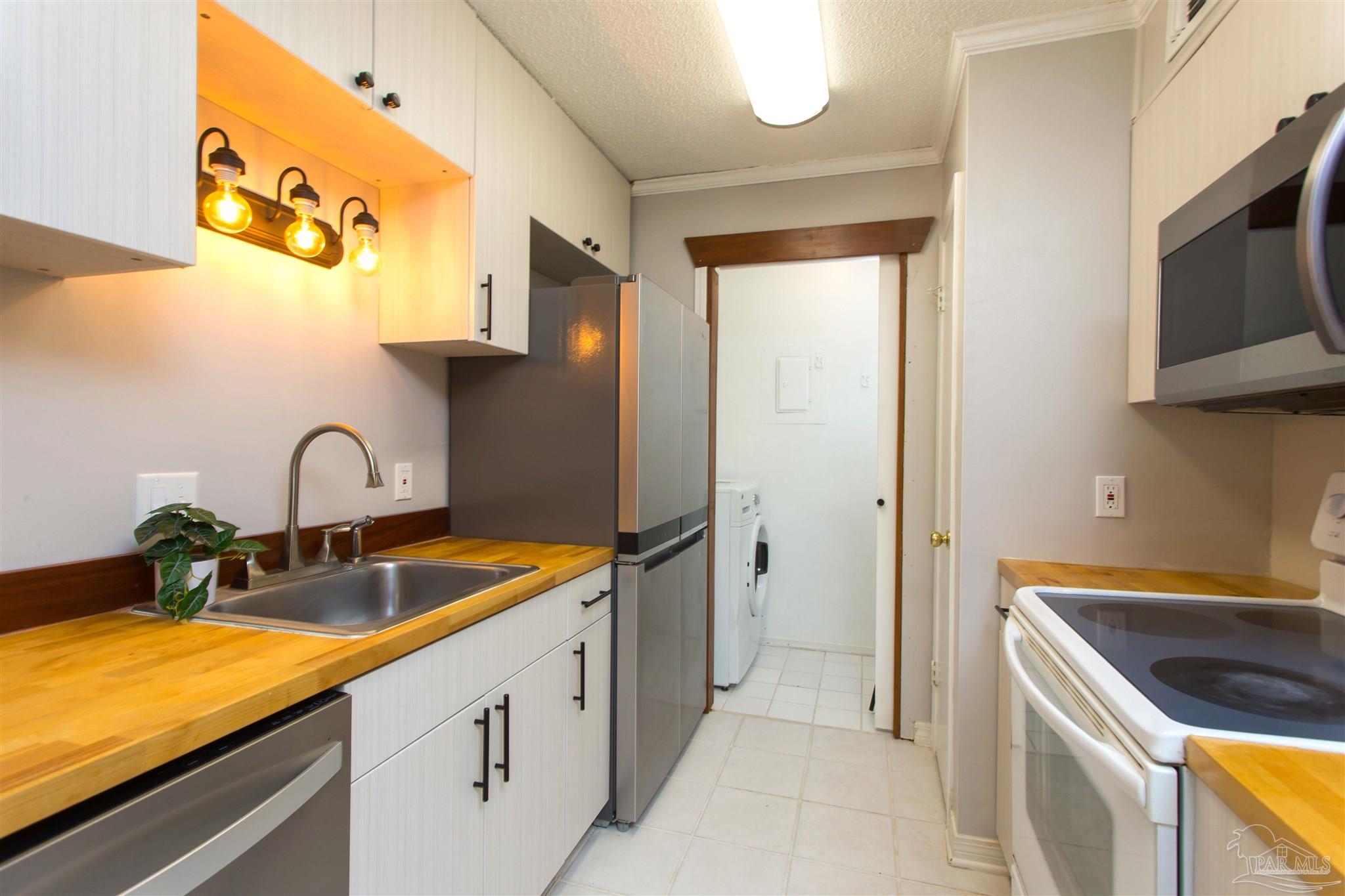 2299 Scenic Highway, Unit R10 Pensacola, FL 32503 - Photo 11 of 31 a kitchen with stainless steel appliances granite countertop a sink and a microwave