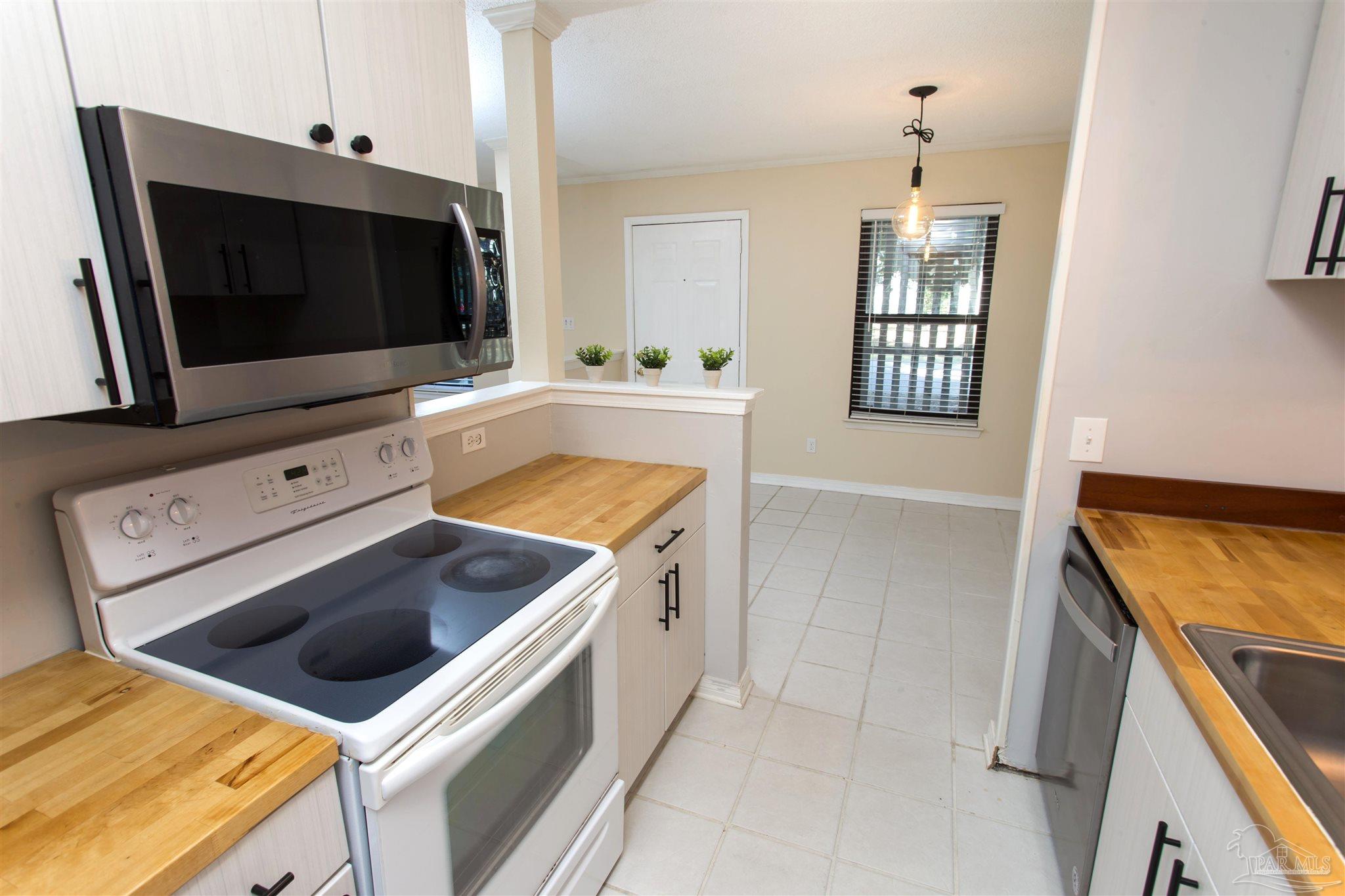2299 Scenic Highway, Unit R10 Pensacola, FL 32503 - Photo 12 of 31 a kitchen with a stove and a microwave
