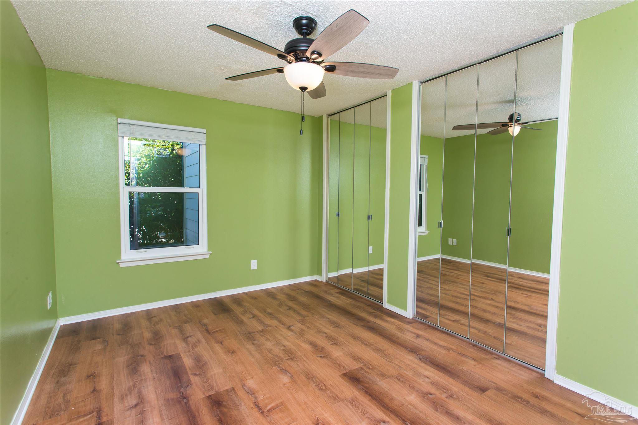 2299 Scenic Highway, Unit R10 Pensacola, FL 32503 - Photo 17 of 31 a view of a room with a large window and a ceiling fan