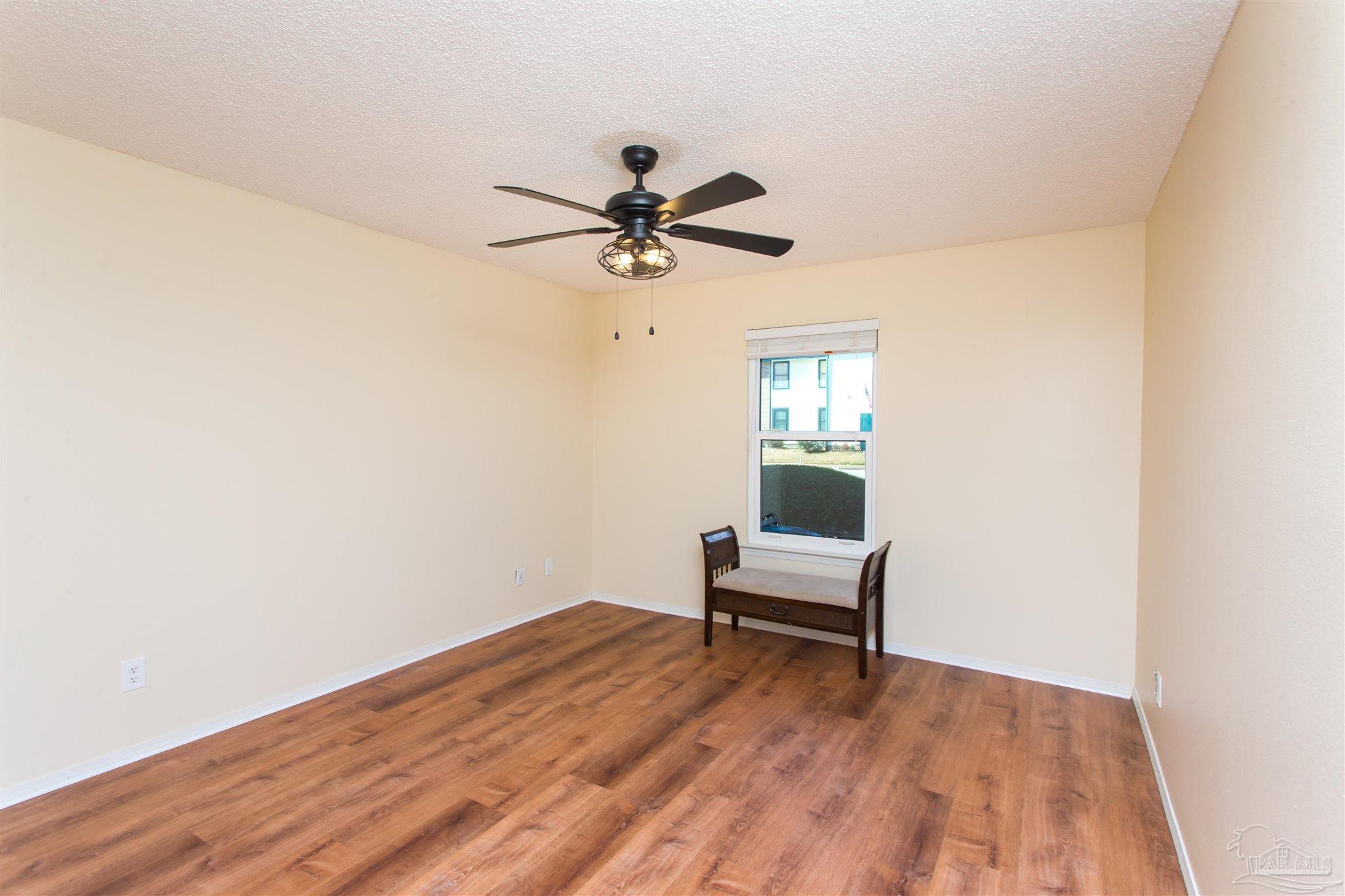 2299 Scenic Highway, Unit R10 Pensacola, FL 32503 - Photo 21 of 31 a view of a workspace with wooden floor and a chandelier fan