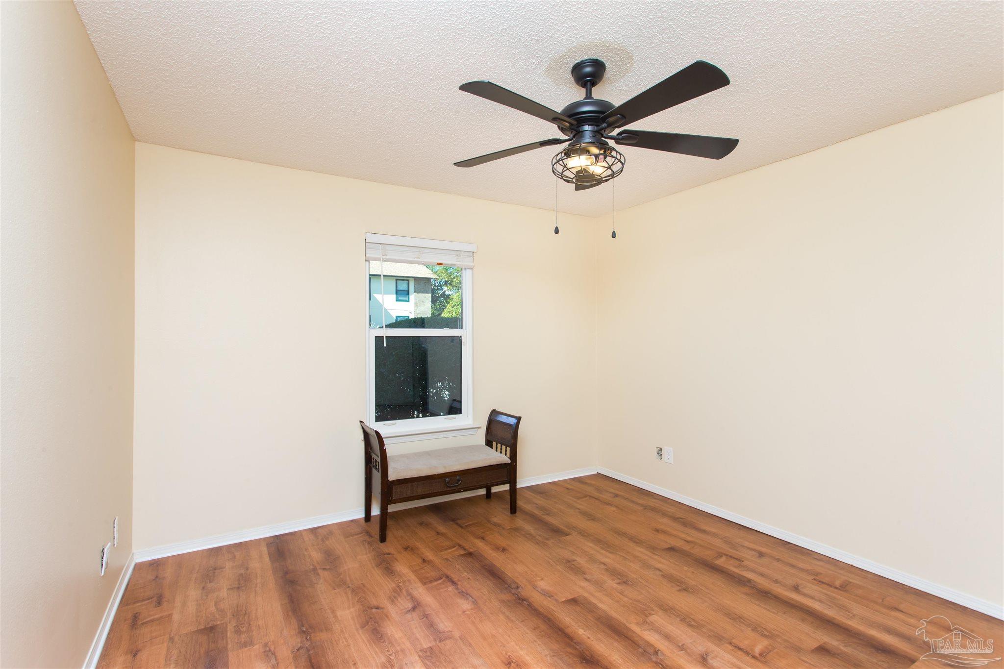 2299 Scenic Highway, Unit R10 Pensacola, FL 32503 - Photo 22 of 31 a view of workspace with wooden floor and ceiling fan