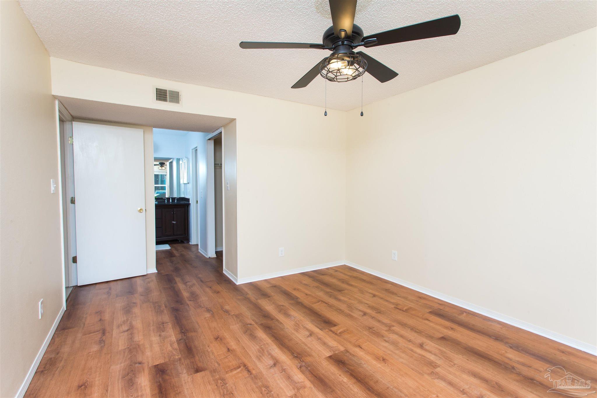 2299 Scenic Highway, Unit R10 Pensacola, FL 32503 - Photo 23 of 31 a view of a big room with wooden floor and a ceiling fan
