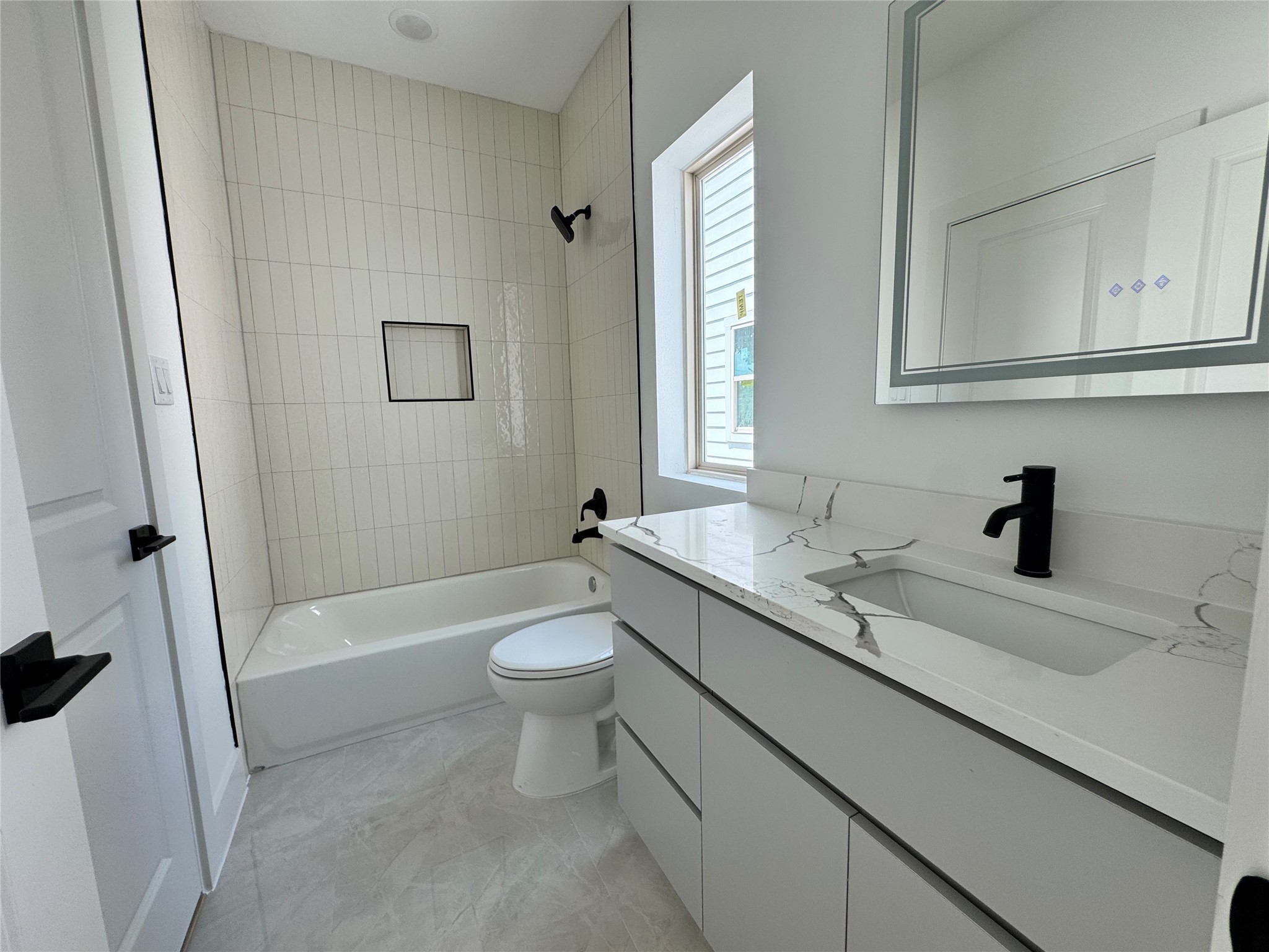 1506 Griffin Street Houston, TX 77009 - Photo 16 of 16 a bathroom with a sink a toilet and bathtub