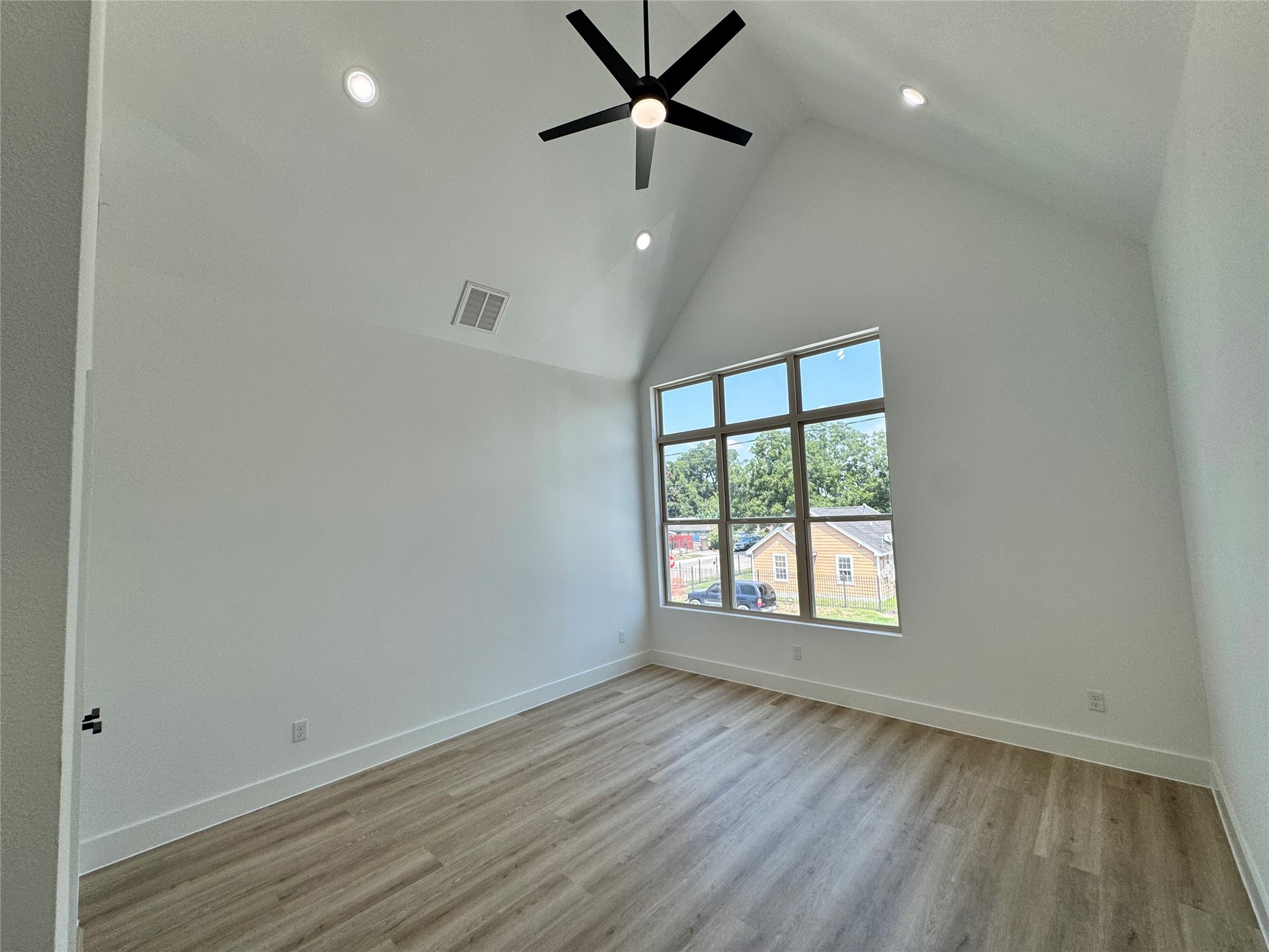 1506 Griffin Street Houston, TX 77009 - Photo 10 of 16 an empty room with wooden floor and windows