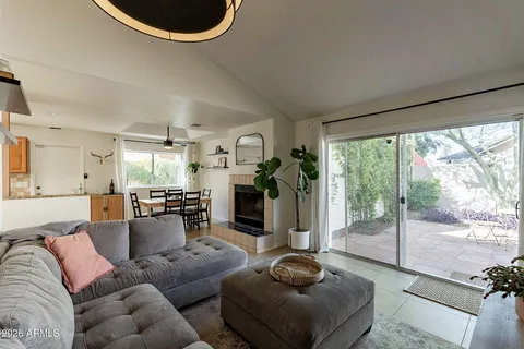 a living room with furniture and a floor to ceiling window