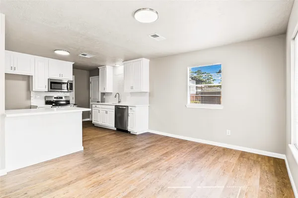 a kitchen with stainless steel appliances a refrigerator sink and cabinets