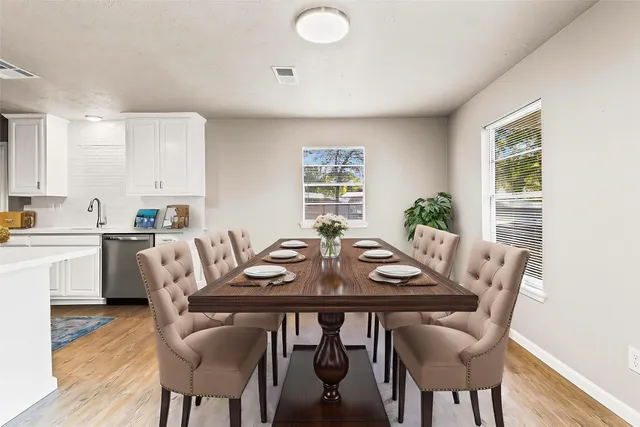 a view of a kitchen with furniture and stainless steel appliances
