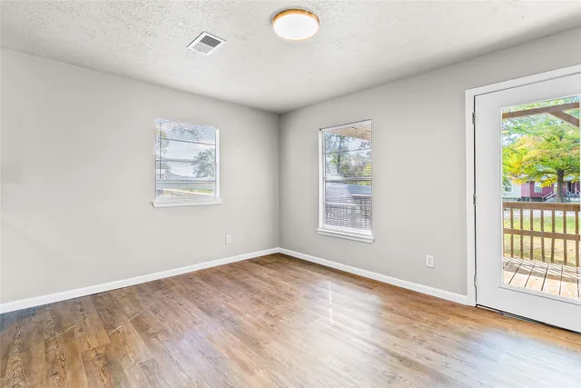 wooden floor in an empty room with a window