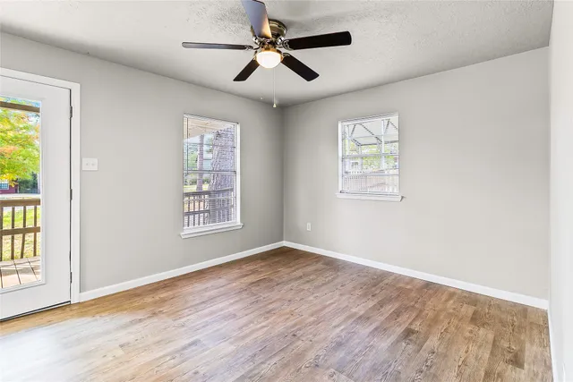 wooden floor in an empty room with a window
