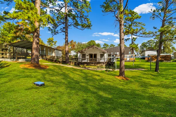 a view of yard with swimming pool and trees