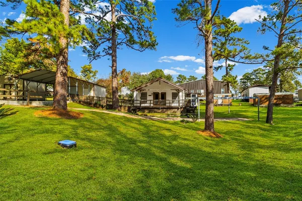 a backyard of a house with table and chairs