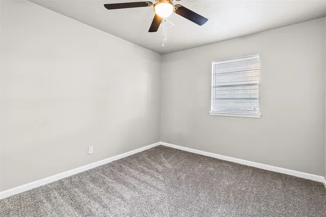 a bedroom with a large bed and a potted plant