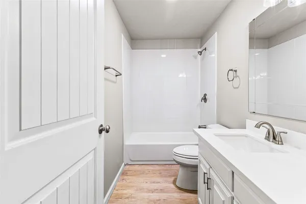 a bathroom with a sink a toilet and a large mirror