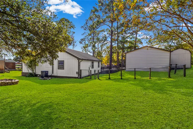 a backyard of a house with table and chairs
