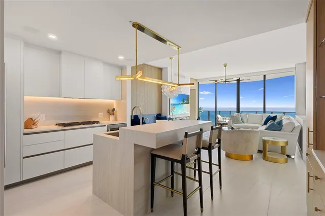 a spacious bedroom with a large bed and a chandelier