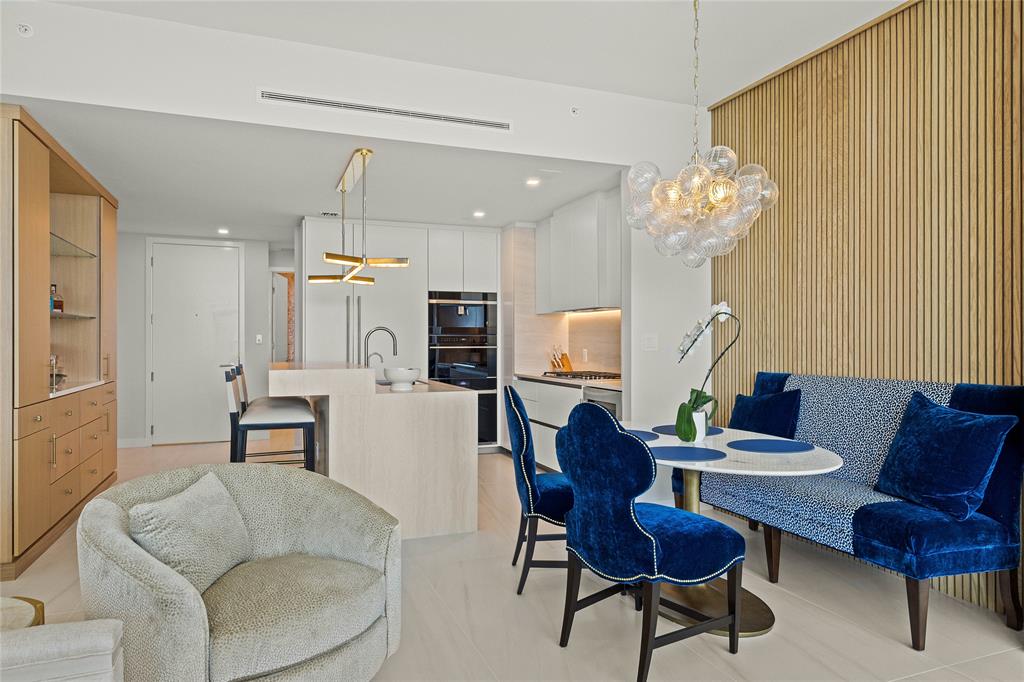 900 North Ocean Boulevard, Unit LPH05 Pompano Beach, FL 33062 - Photo 12 of 69 a living room with furniture a dining table and a chandelier