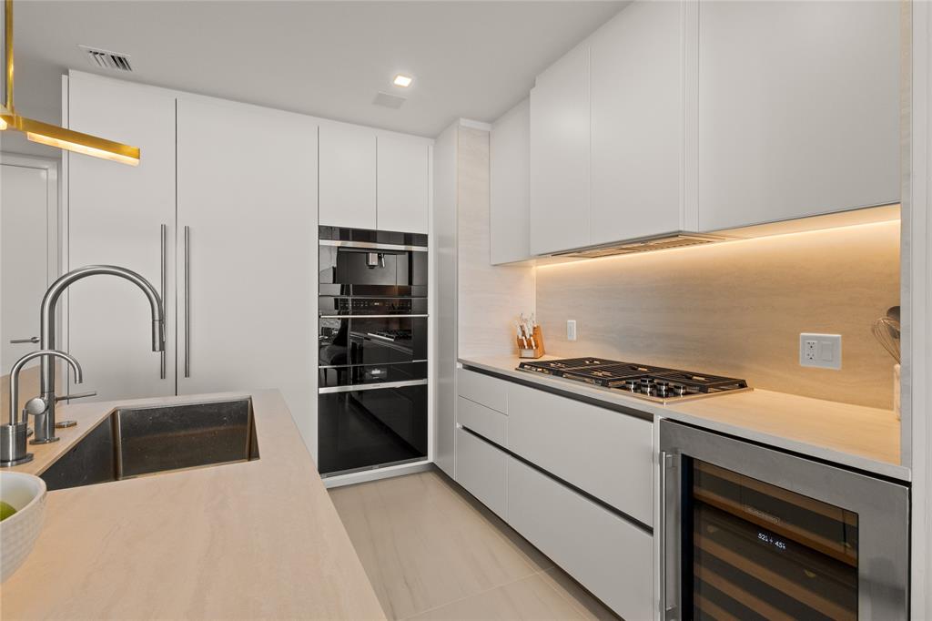 900 North Ocean Boulevard, Unit LPH05 Pompano Beach, FL 33062 - Photo 14 of 69 a kitchen with stainless steel appliances granite countertop a stove and a refrigerator