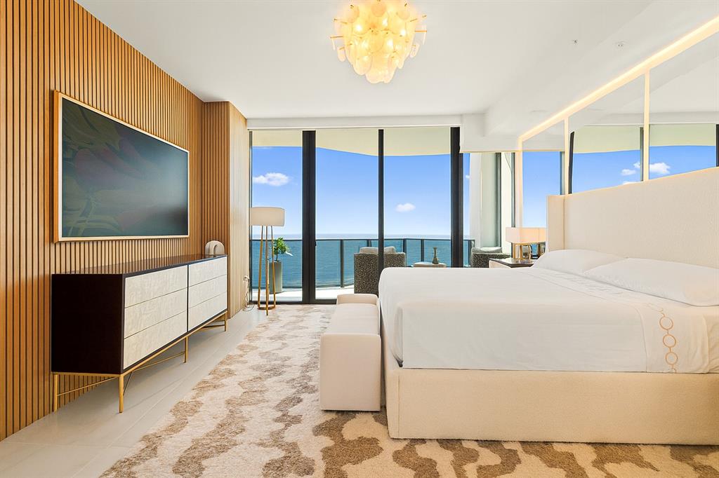 900 North Ocean Boulevard, Unit LPH05 Pompano Beach, FL 33062 - Photo 17 of 69 a living room with a large window and a flat screen tv