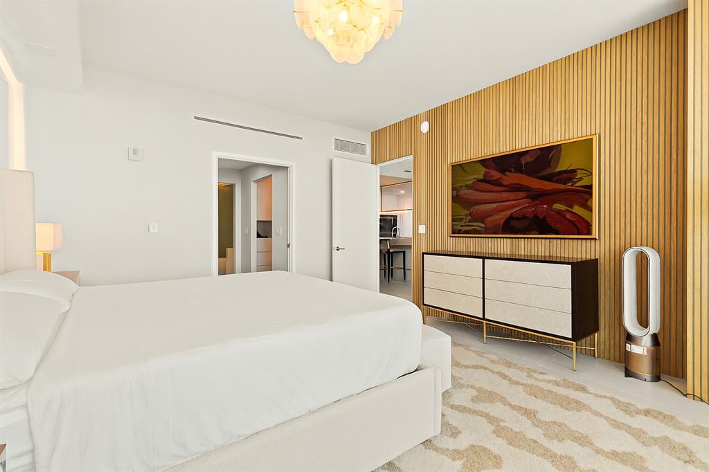 900 North Ocean Boulevard, Unit LPH05 Pompano Beach, FL 33062 - Photo 18 of 69 a bedroom with a bed and a painting on the wall