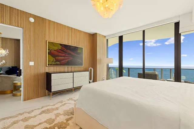 a bedroom with a large bed and a large window