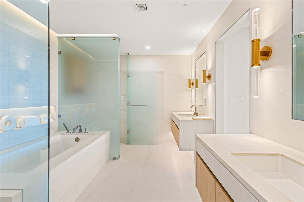 900 North Ocean Boulevard, Unit LPH05 Pompano Beach, FL 33062 - Photo 23 of 69 a bathroom with a tub a sink and mirror