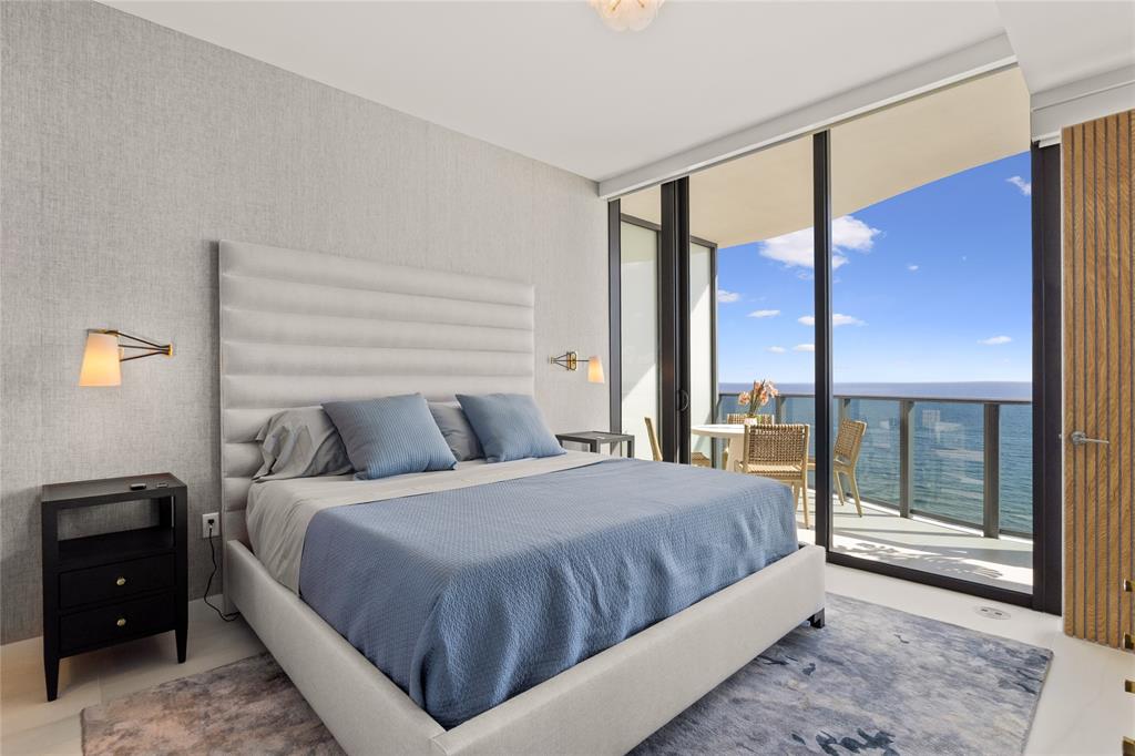 900 North Ocean Boulevard, Unit LPH05 Pompano Beach, FL 33062 - Photo 24 of 69 a bedroom with a large bed and a large window