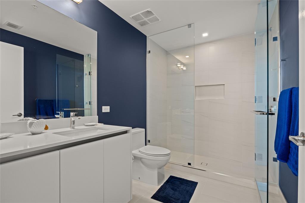 900 North Ocean Boulevard, Unit LPH05 Pompano Beach, FL 33062 - Photo 26 of 69 a bathroom with a sink a toilet and shower