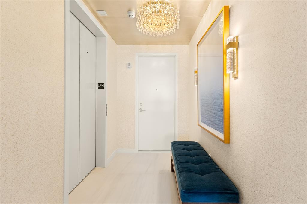 900 North Ocean Boulevard, Unit LPH05 Pompano Beach, FL 33062 - Photo 31 of 69 a view of hallway with windows and a ceiling fan