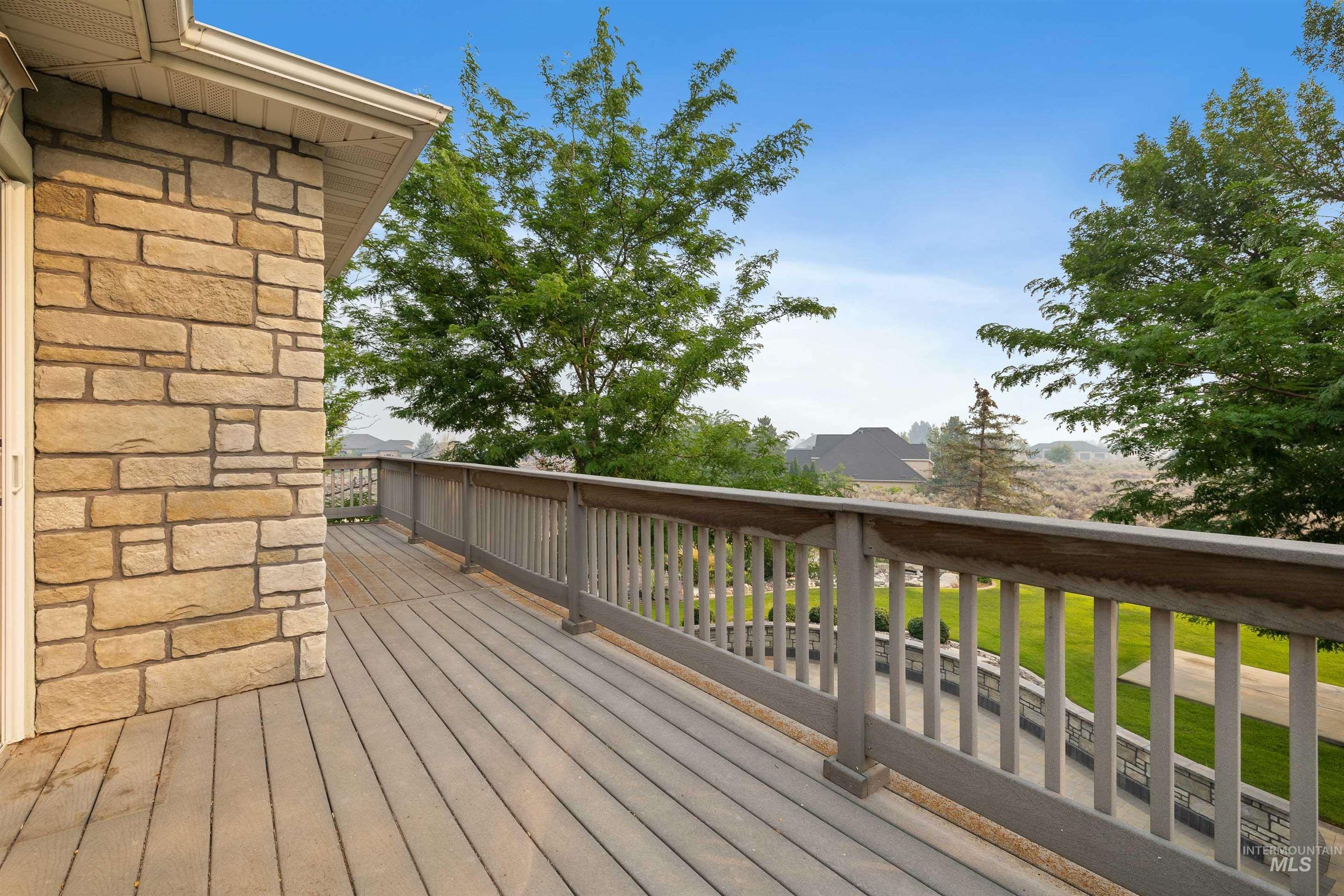 3404 Ridge Line Drive Kimberly, ID 83341 - Photo 31 of 50 Exterior deck with a stone-clad wall, composite decking, and a wooden railing