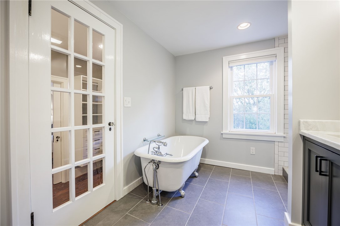 387 Kilbourn Road Rochester, NY 14618 - Photo 23 of 42 An elegant clawfoot tub anchors this beautifully finished space featuring DESIGNER tile flooring.