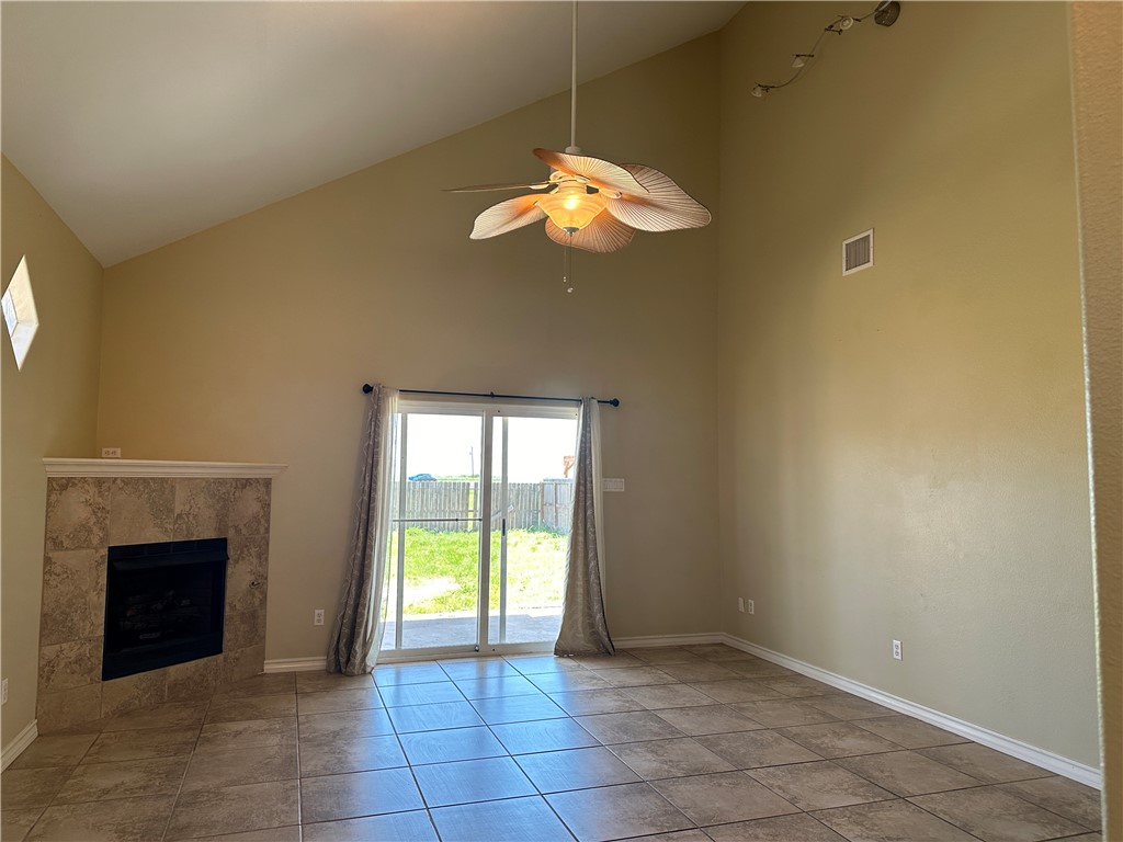 14010 Ambrosia Street, Unit A Corpus Christi, TX 78418 - Photo 2 of 13 a view of an empty room with a fireplace and a window
