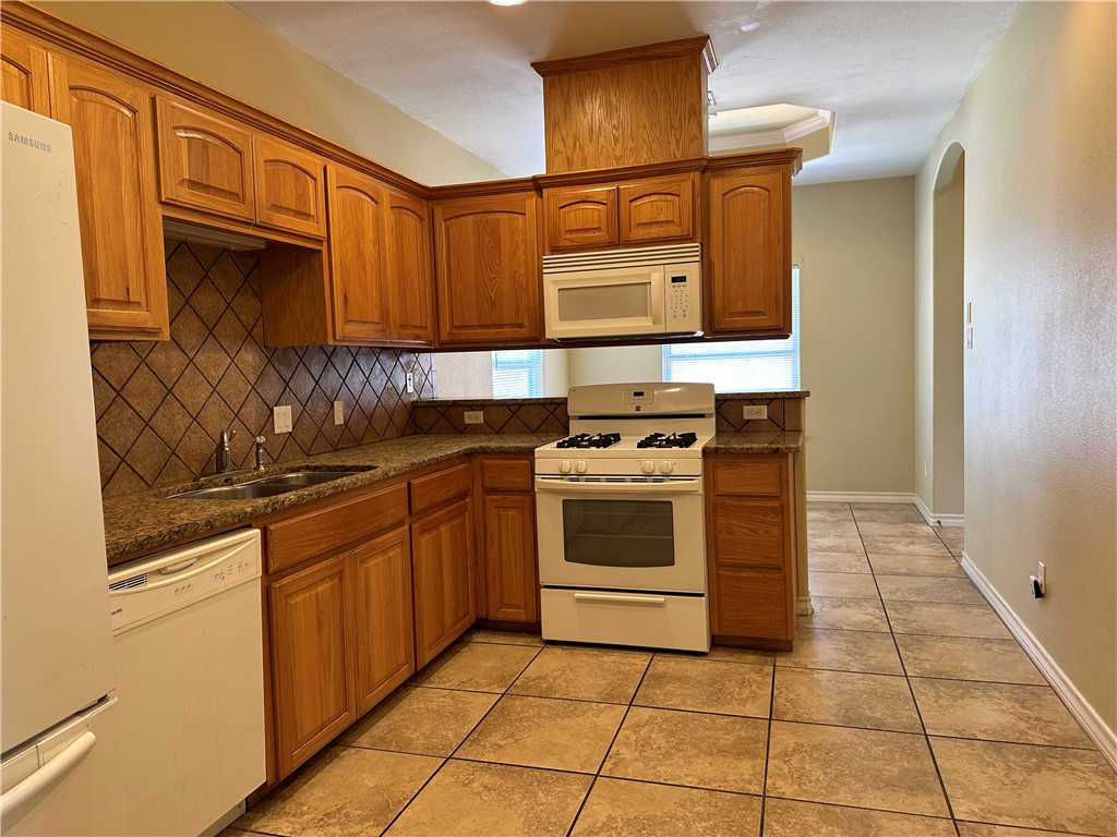 14010 Ambrosia Street, Unit A Corpus Christi, TX 78418 - Photo 6 of 13 a kitchen with stainless steel appliances granite countertop a stove and a sink