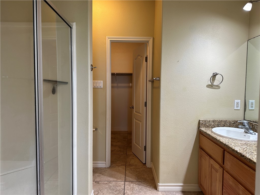 14010 Ambrosia Street, Unit A Corpus Christi, TX 78418 - Photo 9 of 13 a bathroom with a granite countertop sink and a mirror