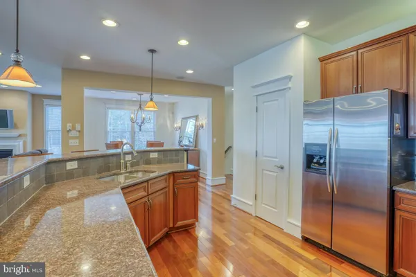 a view of a dining room with furniture a chandelier and wooden floor