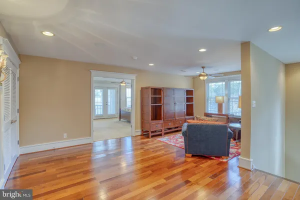 a spacious bathroom with a tub a sink and mirrors