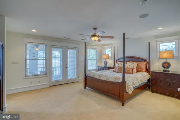 a bedroom with a bed and a lamp on dresser