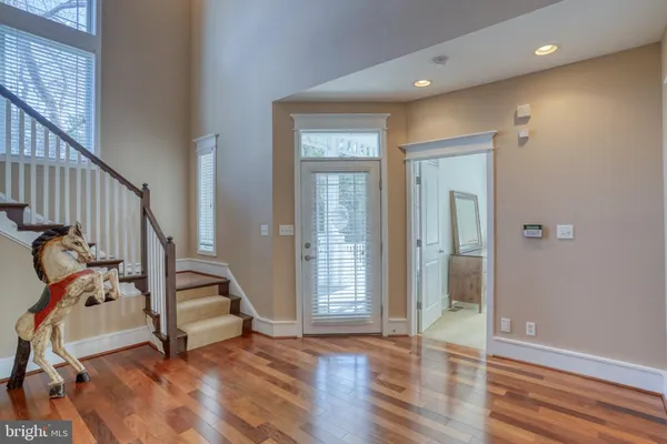 a view of entryway and hall with wooden floor
