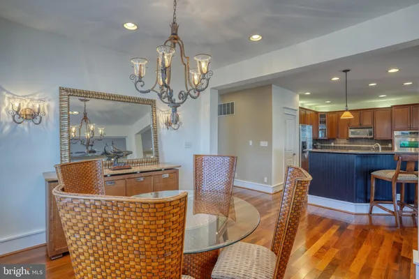a living room with furniture kitchen view and a window