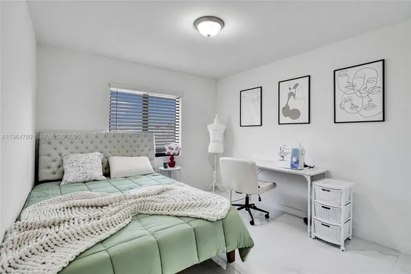 a bedroom with a bed and a desk