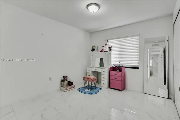 a bedroom with furniture and a window