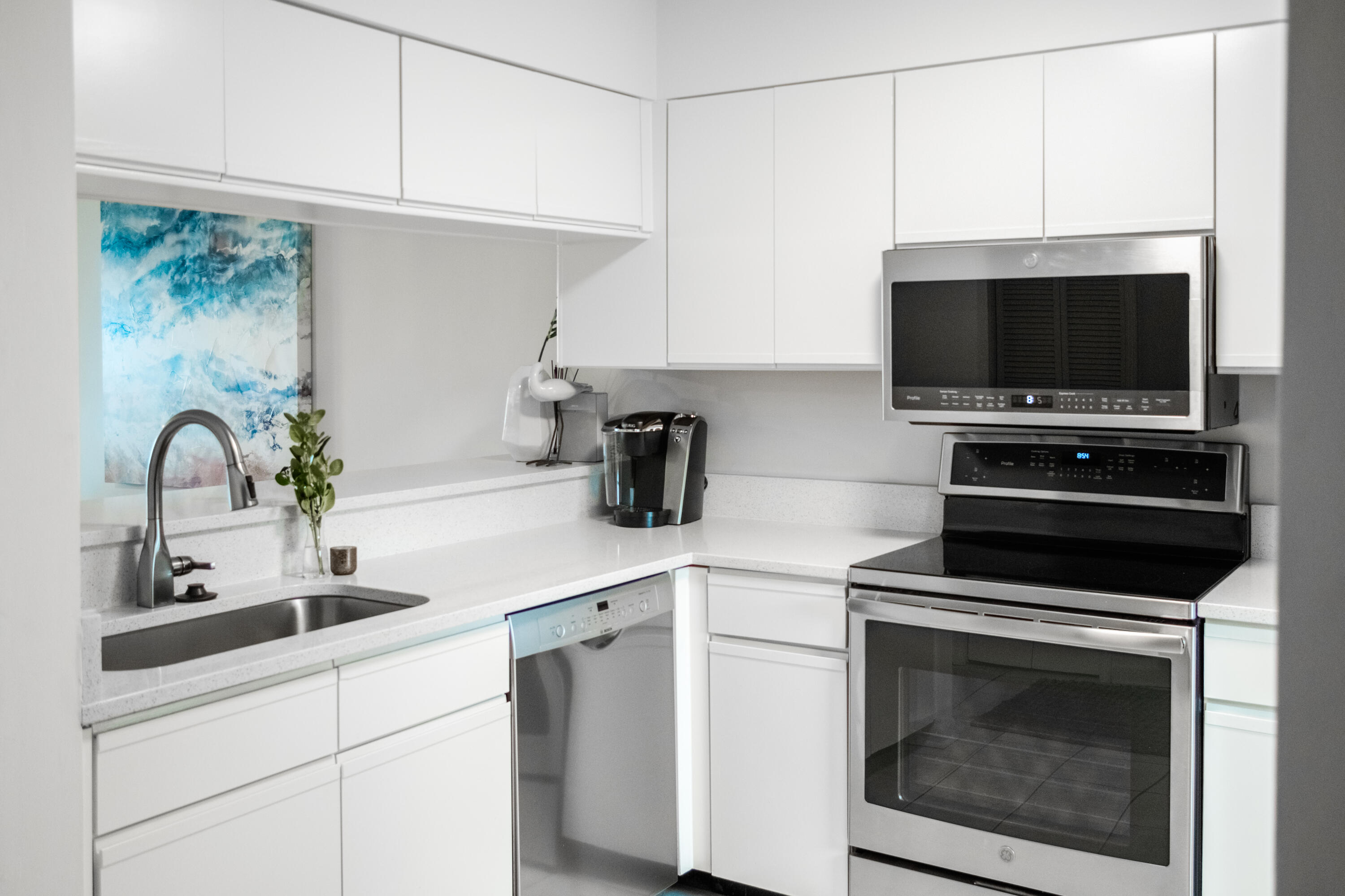 23011 Front Beach Road, Unit 58 Panama City Beach, FL 32413 - Photo 15 of 32 a kitchen with a sink and a stove top oven