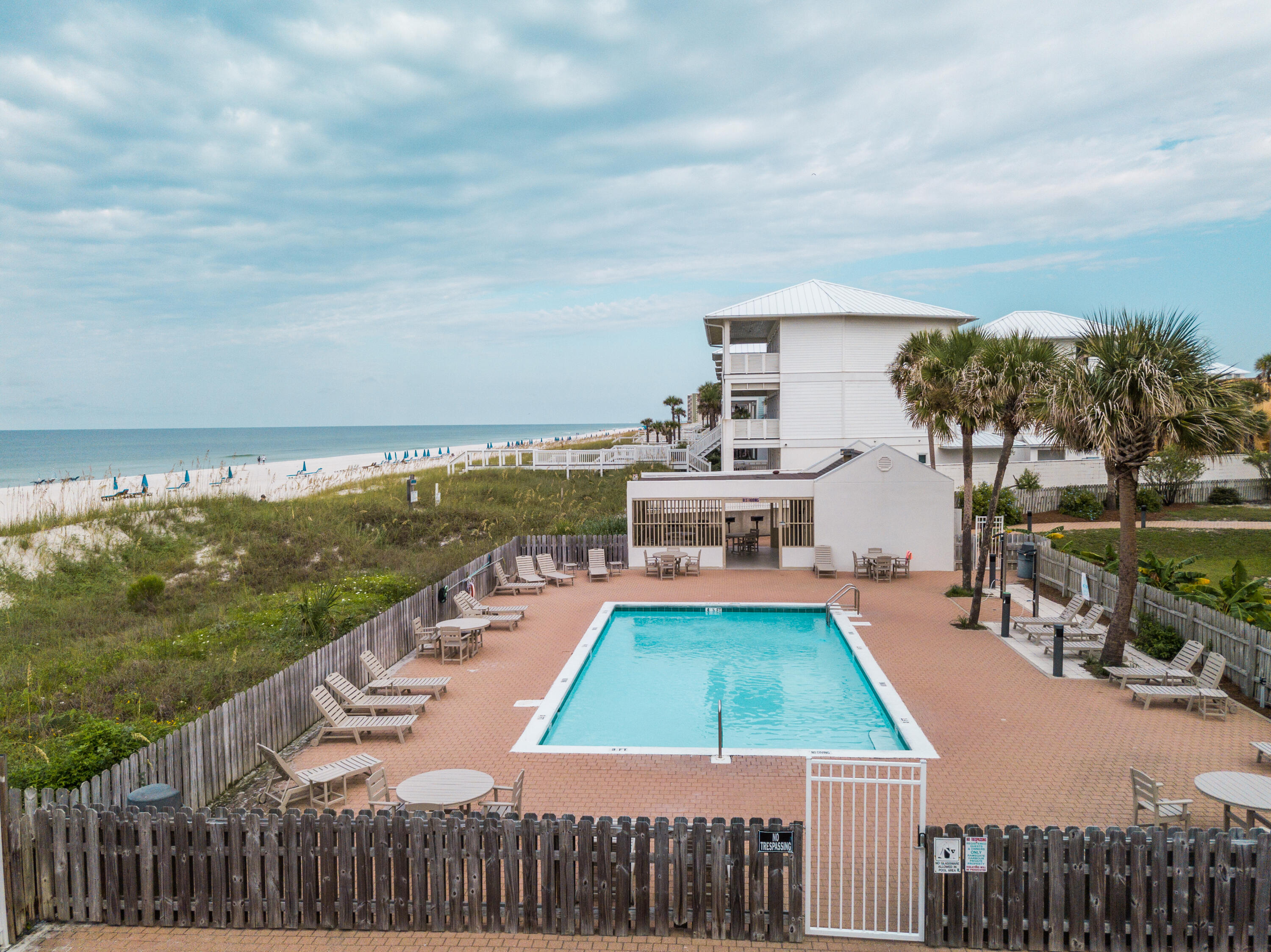 23011 Front Beach Road, Unit 58 Panama City Beach, FL 32413 - Photo 27 of 32 a view of a swimming pool and lounge chairs